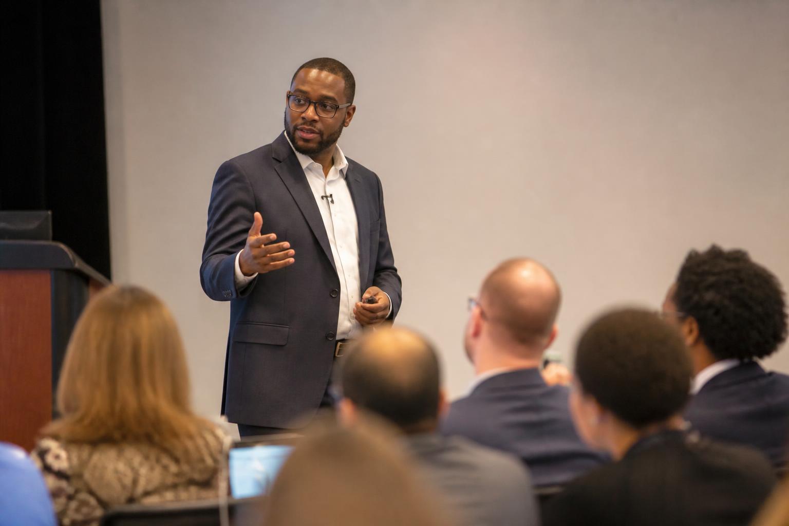 Leonard Mukosi presenting to a seated audience
